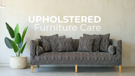 Picture of a black and white Begin Interiors sofa and the writing Upholstered furniture care